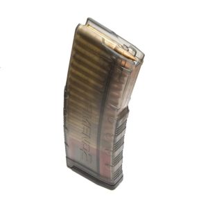 Transparent smoke-colored rifle magazine loaded with brass ammunition rounds, standing upright against a white background.
