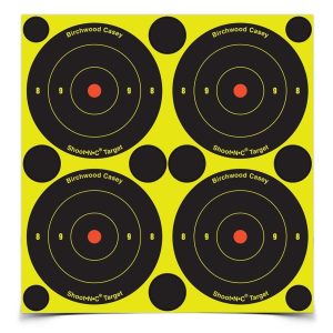 Yellow and black target sheet with four circular shooting targets and red center dots, labeled "Birchwood Casey Shoot-N-C Target."