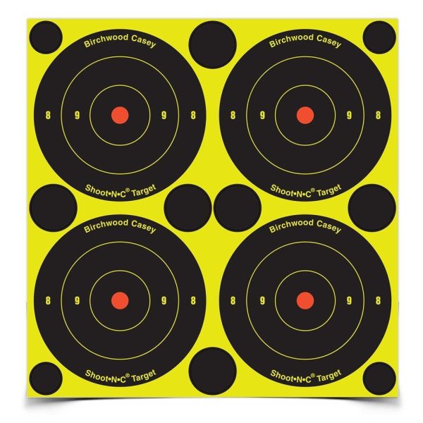 Yellow and black target sheet with four circular shooting targets and red center dots, labeled "birchwood casey shoot-n-c target. "