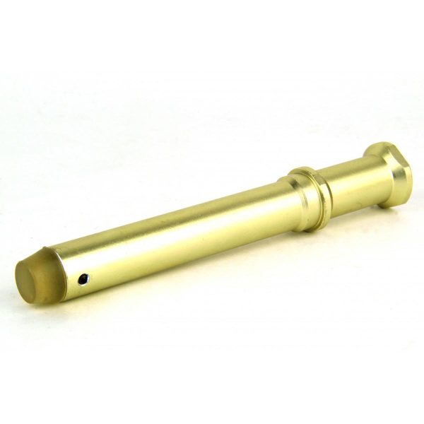 Gold-colored metal firearm part with a cylindrical shape, resting on a white surface.