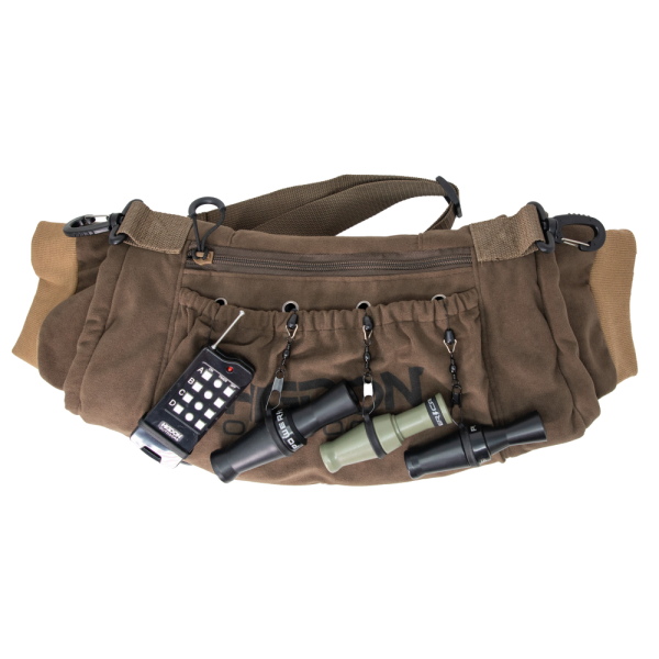 Brown tactical bag with multiple pouches, displaying black and green ammo accessories, designed for firearms storage; photographed in casey, iowa.