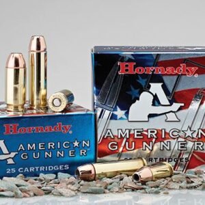 Boxes of hornady american gunner ammunition with cartridges displayed on gravel surface.