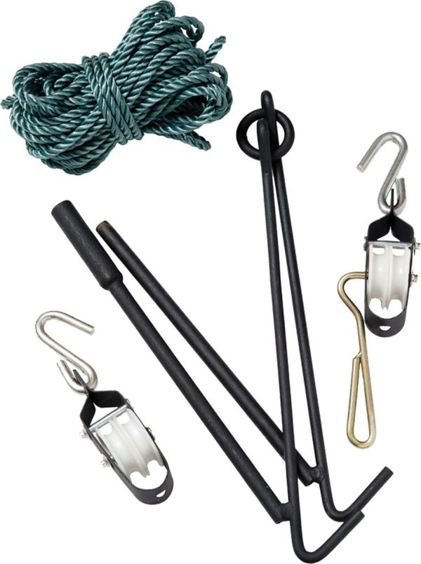 A green rope, black metal rods, pulleys, and hooks laid out for gear setup.