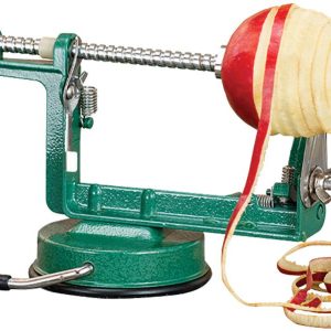 A green apple peeler with a suction base, peeling a red and yellow apple, with curled apple peels beside it.