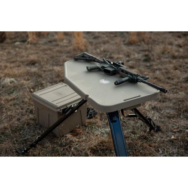 Rifle on tan shooting table outdoors with ammo box nearby, casey, iowa.
