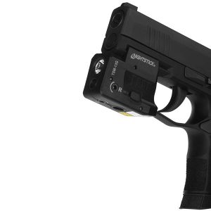 Black handgun with a Nightstick TSM-13G tactical light and laser attachment.