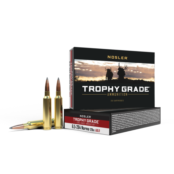 Nosler trophy grade ammunition box with two gold bullets, featuring a scenic design with silhouettes of hunters in a sunset landscape, labeled 6. 5-284 norma 129gr ablr.