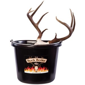 A black plastic bucket labeled "The Buck Boiler" with a deer skull and large antlers emerging from the top, featuring a flame design on the label.