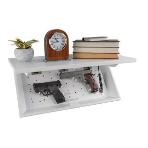 White wall-mounted shelf with a secret compartment displaying two handguns, a plant, a clock, and stacked books, related to firearms in Casey, Iowa.