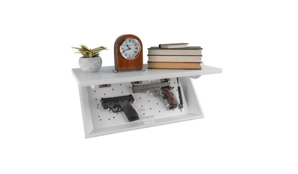 White wall-mounted shelf with a secret compartment displaying two handguns, a plant, a clock, and stacked books, related to firearms in casey, iowa.