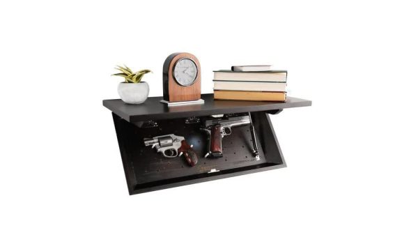 Black wall-mounted shelf with concealed compartment holding two handguns, a silver revolver, and a pistol with a wooden grip; top decorated with a small potted plant, a wooden clock, and stacked books.