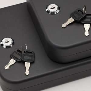 Black security lock boxes with two pairs of silver keys, featuring round locks with engraved numbers.