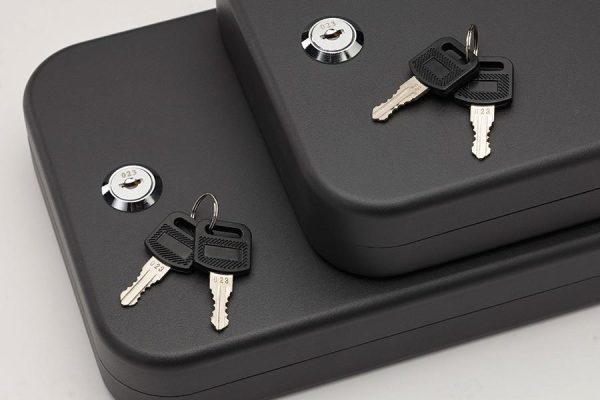 Black security lock boxes with two pairs of silver keys, featuring round locks with engraved numbers.