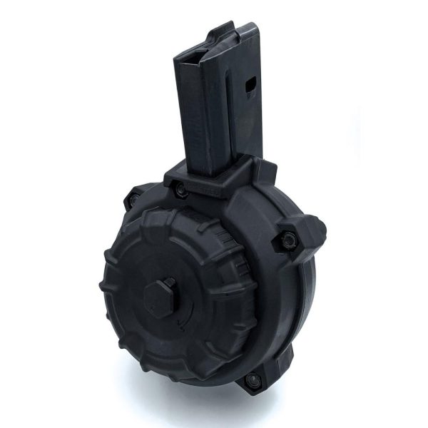 Black drum magazine with a matte finish for firearms, featuring a ribbed exterior and rectangular feeding slot, on a white background.