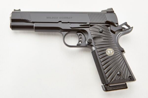 Black wilson combat handgun with textured grip and logo, isolated on white background.