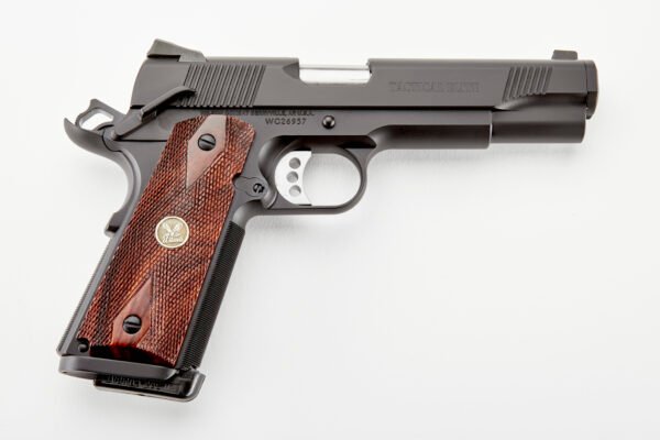 Black tactical pistol with silver trigger and dark wooden grip featuring detailed texturing and an emblem on the handle, set against a white background.