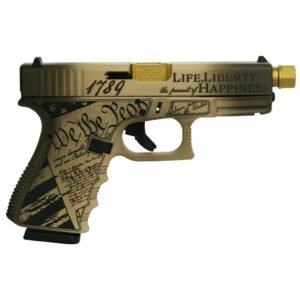 Beige and black customized handgun with "we the people" and "life, liberty and the pursuit of happiness" engravings, featuring a gold barrel tip.