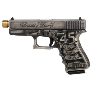 A custom gray and black handgun with gold details, featuring engraved text and American symbols on the grip.