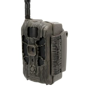 A dark green and black camo-patterned Stealth Cam trail camera with a rugged, textured exterior and an antenna on the top left side.