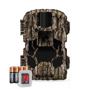 Camouflage-patterned trail camera with black accents, accompanied by four Duracell batteries and a memory card in a clear case.