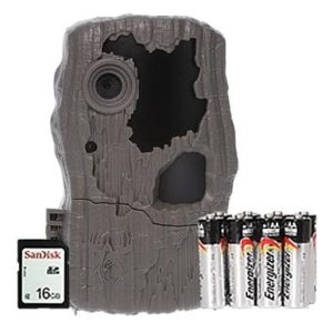 A camouflaged trail camera with a textured brown exterior, accompanied by a SanDisk 16GB card and eight Energizer batteries.