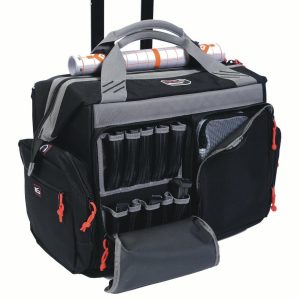 Black and gray tactical bag with multiple compartments, red zipper pulls, and mesh pocket, designed for firearms and ammo storage, featuring a roll of paper secured on top.