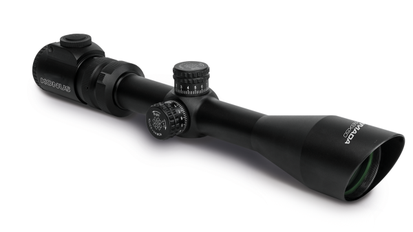 Black konus rifle scope with adjustment knobs and a green-tinted lens.