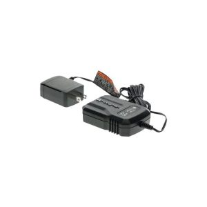 A black electrical charger with a power adapter and cord plugged in, isolated on a white background.