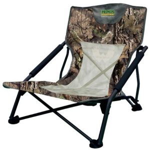 Camo folding chair with mesh back and armrests.