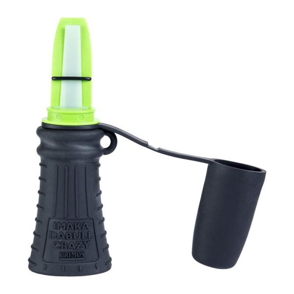 A black deer call with a bright green mouthpiece and "imaka dabull crazy primos" branding, featuring a side cup attachment.