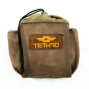 Brown mesh bag with "TETHRD" logo in orange, featuring a black drawstring closure.