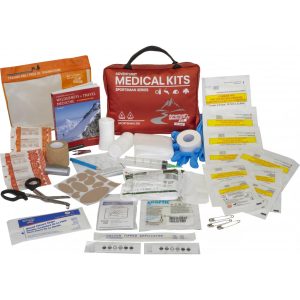 Red medical kit bag with various medical supplies, including bandages, gauze, scissors, adhesive strips, gloves, and safety pins.