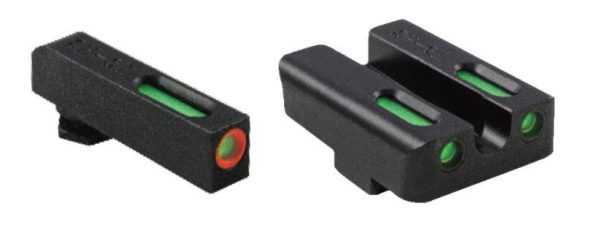 Black firearm sights with green fiber optic inserts and a red-ringed front sight.