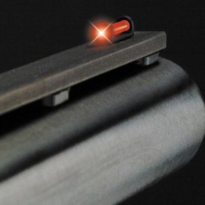 Barrel of a firearm with a glowing red front sight against a black background.