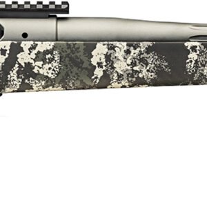 Rifle with a gray and black camouflage stock, black trigger and bolt, and a silver fluted barrel with a muzzle brake.