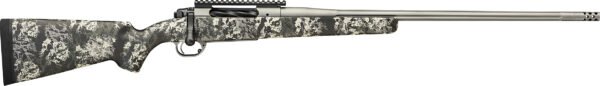 Rifle with a gray and black camouflage stock, black trigger and bolt, and a silver fluted barrel with a muzzle brake.