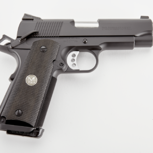 Black semi-automatic handgun with textured grip, lying on a white surface; associated with firearms, guns, and ammo in casey, iowa.