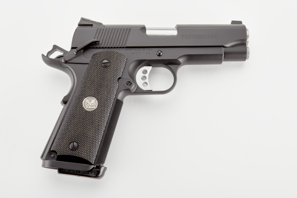 Black semi-automatic handgun with textured grip, lying on a white surface; associated with firearms, guns, and ammo in casey, iowa.