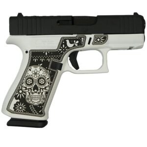 A black and white handgun with a decorative design featuring a skull and floral patterns on the grip.