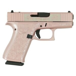 A pink handgun with intricate floral engravings on the grip and slide, displaying a black trigger and magazine base.