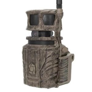 A camouflage-patterned hunting camera with dual lenses and an antenna, resembling a trail monitoring device.