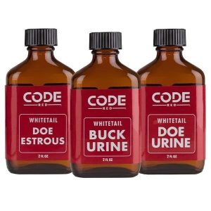 Three brown glass bottles labeled "CODE RED" containing whitetail deer scents: "Doe Estrous," "Buck Urine," and "Doe Urine," each with a 2 oz capacity.
